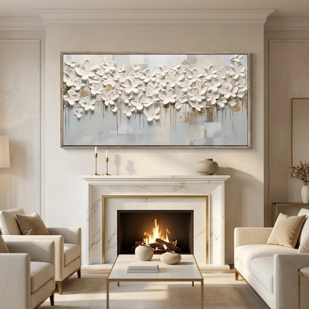 Living room with a fireplace, white floral artwork, and beige decor.