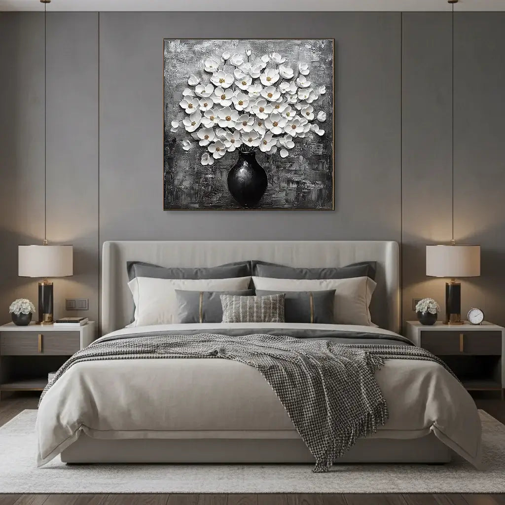Modern bedroom with a bed, nightstands, and a floral painting on the wall.
