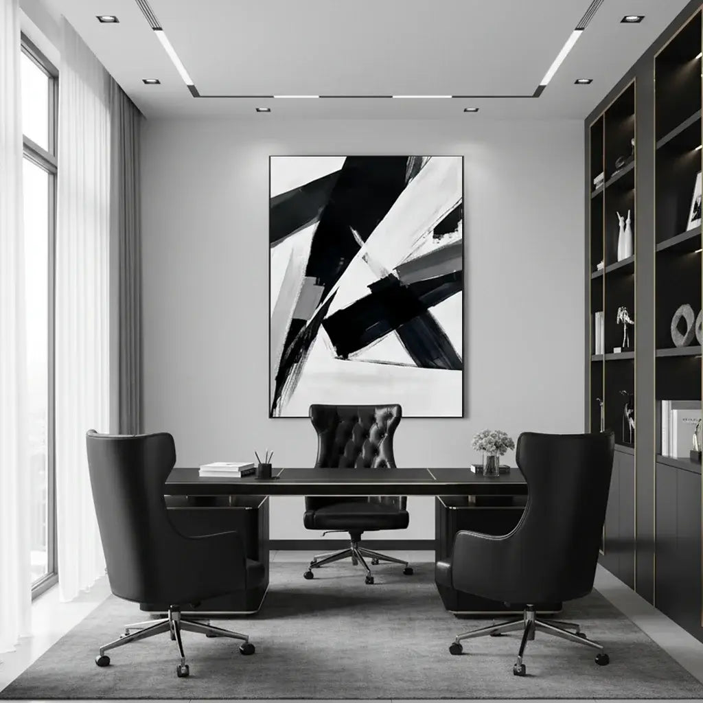 Modern office interior with a black and white abstract painting on the wall.