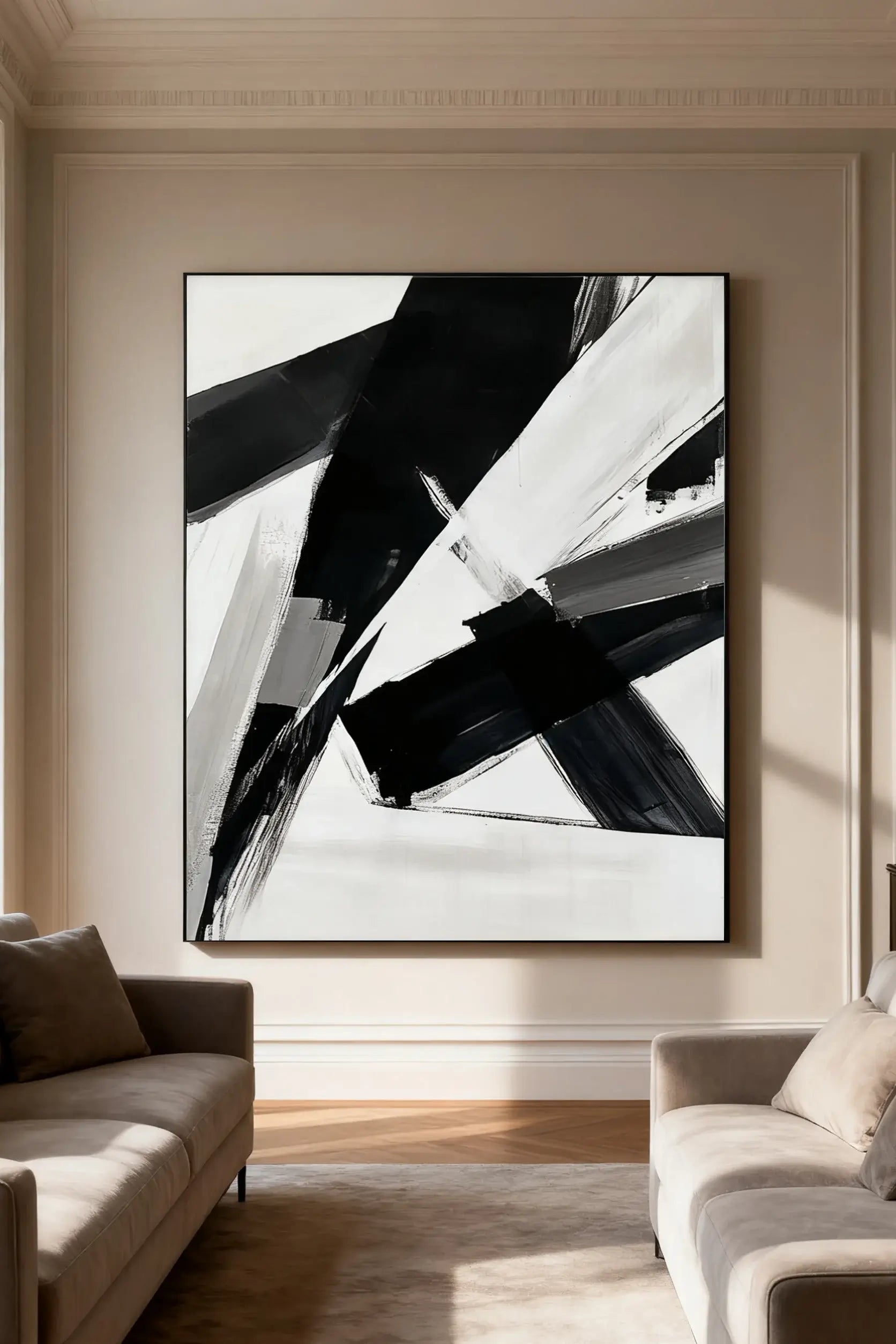 Abstract black and white painting on a wall in a living room setting.