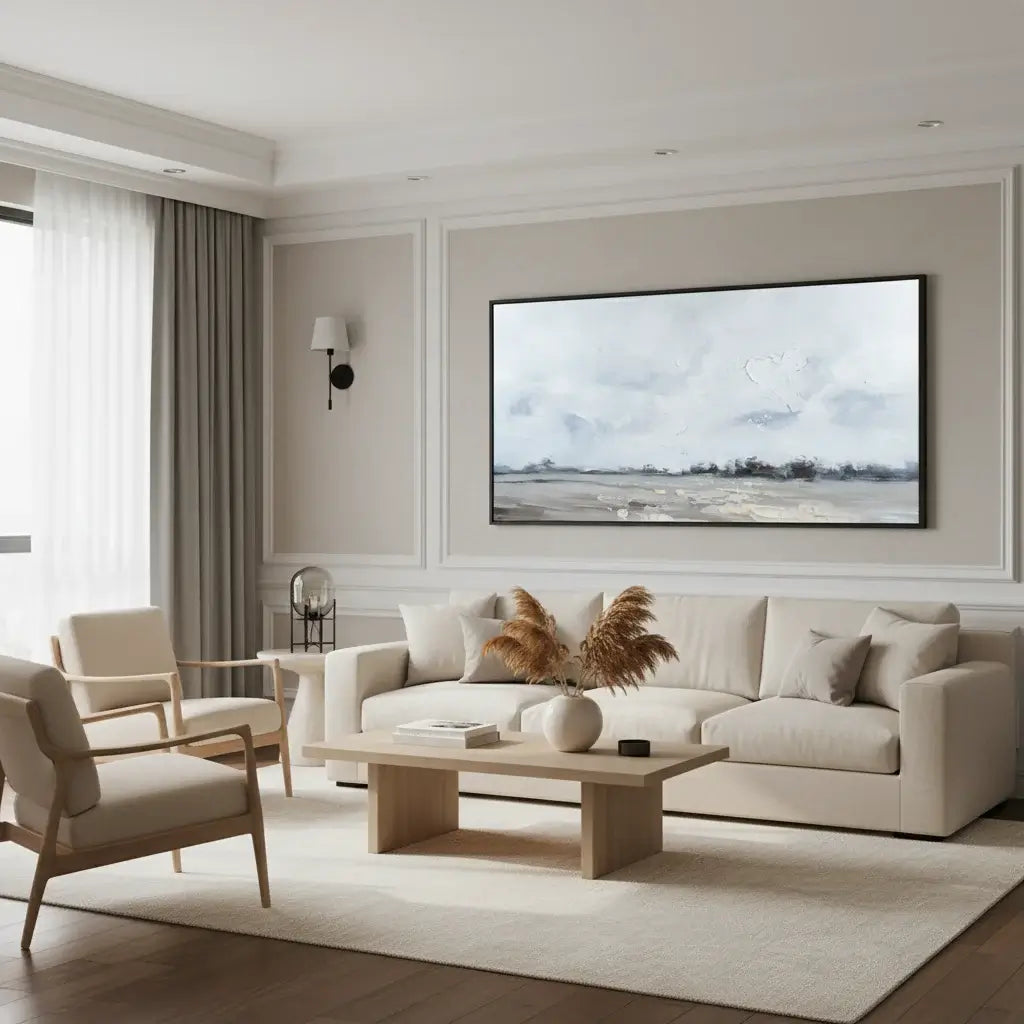 Modern living room with beige sofa, armchairs, and a large wall-mounted TV.