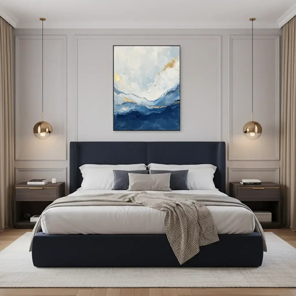 Modern bedroom with a navy bed, abstract painting, and pendant lights.