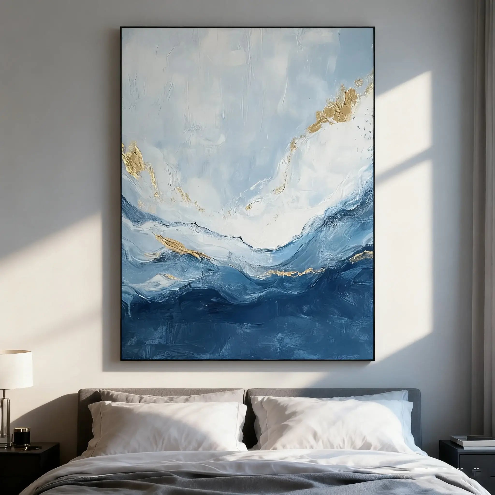 Abstract painting with blue and gold tones above a bed in a bedroom setting.