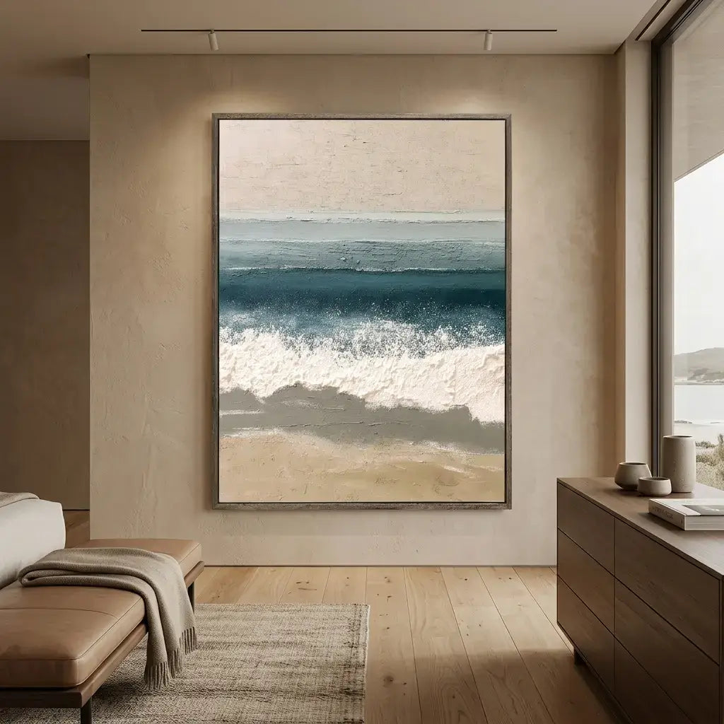 Modern living room with a large framed beach scene painting on a neutral wall.