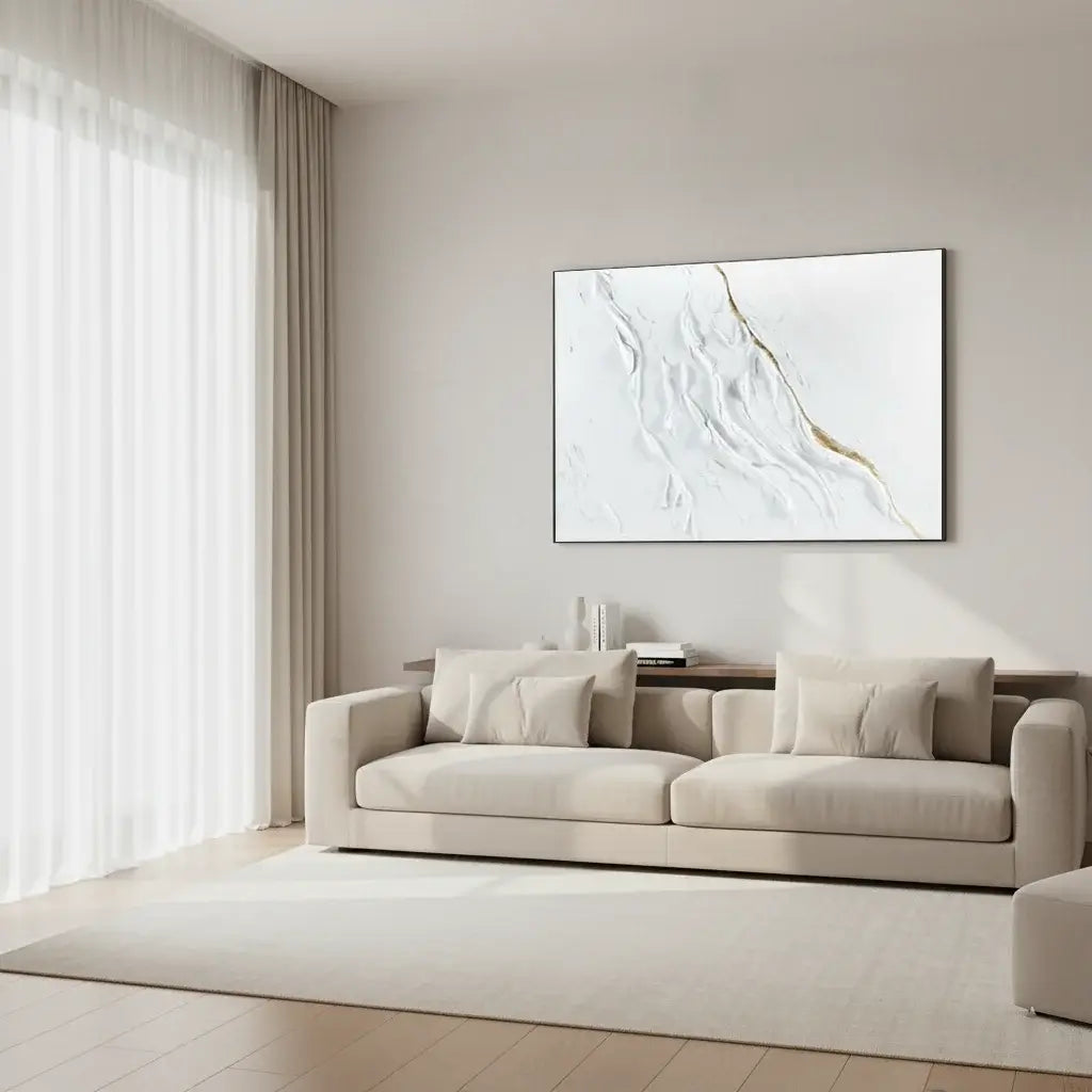 Modern living room with a beige sofa and abstract artwork on the wall.