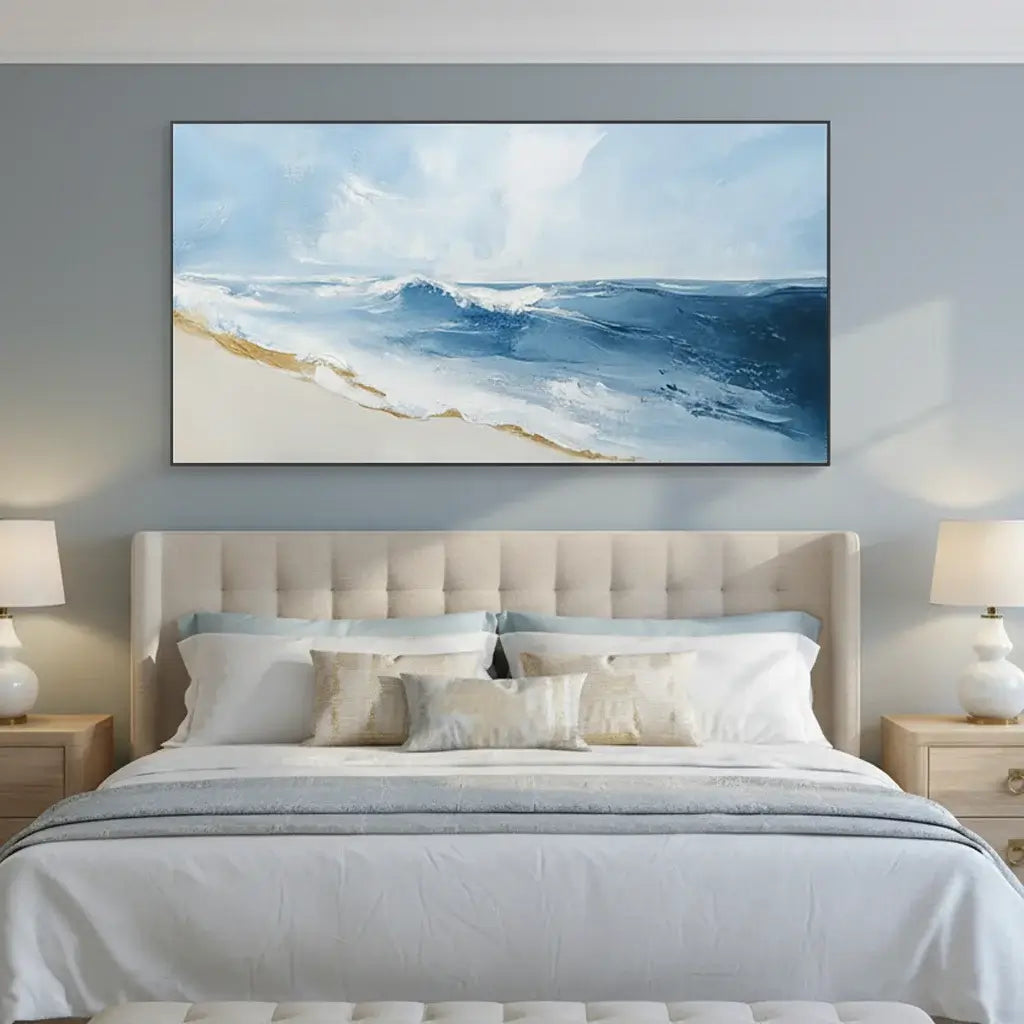 Bedroom with a large framed artwork of a beach scene on the wall.