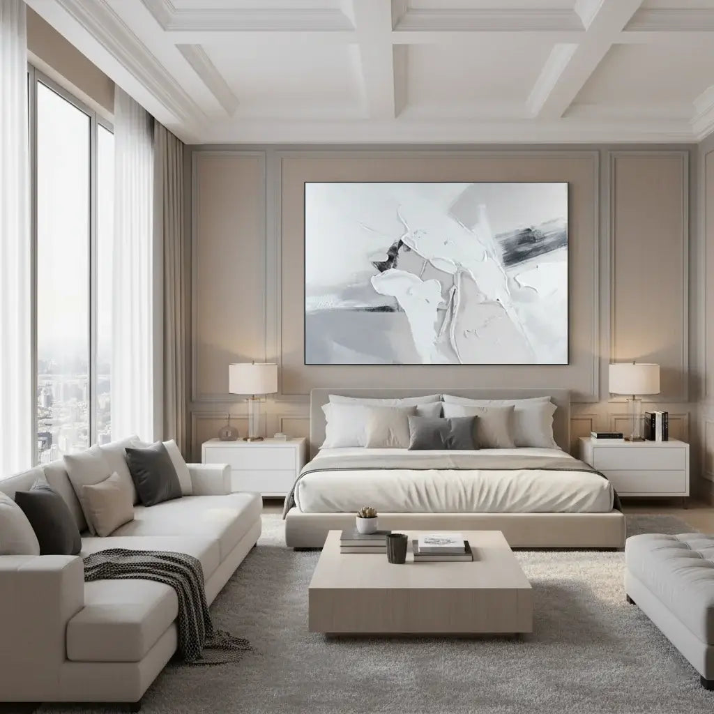 Modern bedroom with a large bed, sofa, and abstract artwork on the wall.