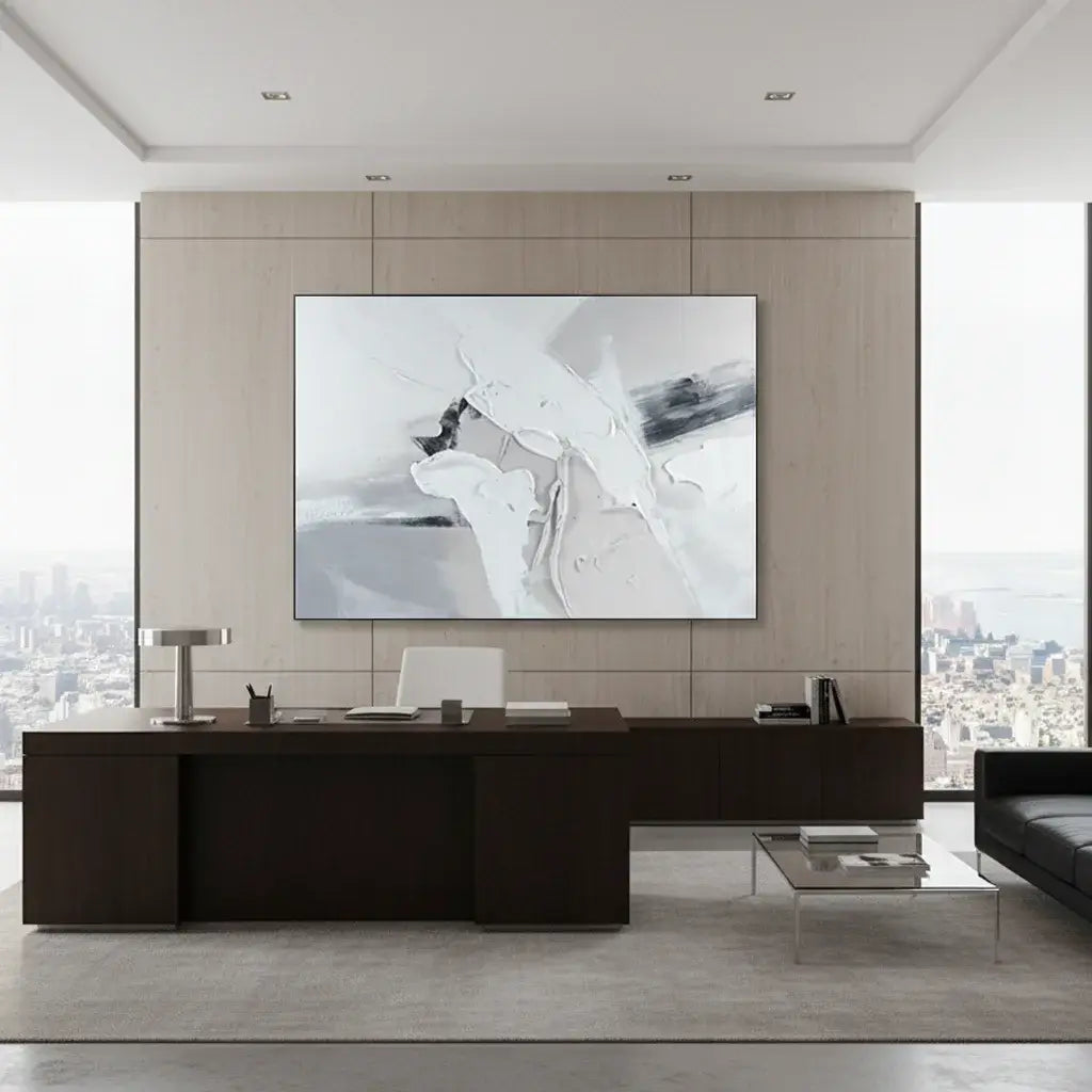 Modern office interior with a large desk and abstract artwork on the wall.