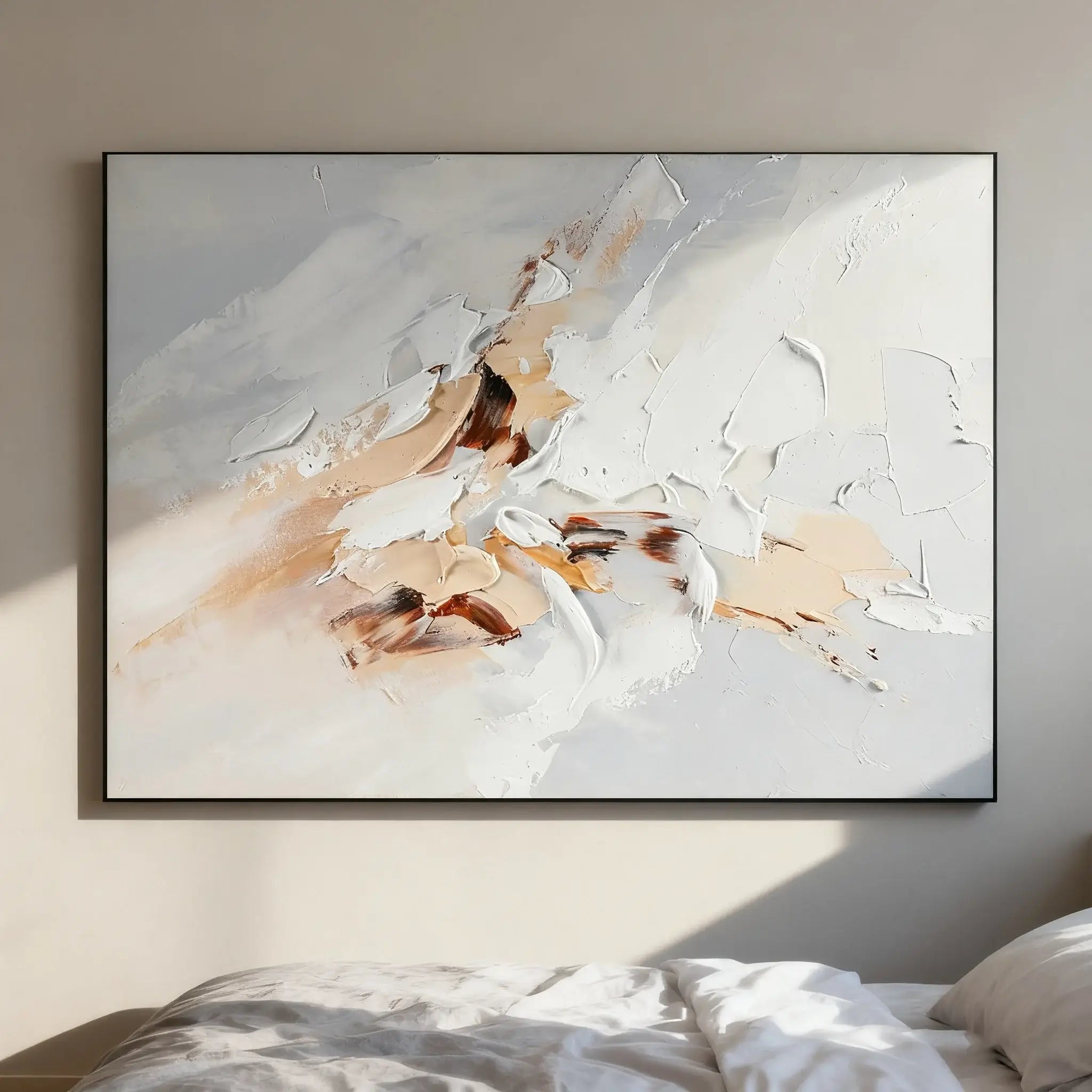Abstract painting with beige and brown tones on a wall above a bed.