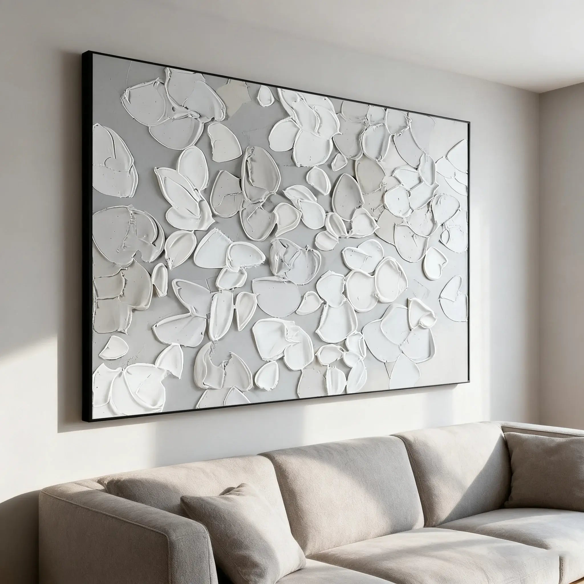 Abstract wall art in a modern living room with a beige sofa.