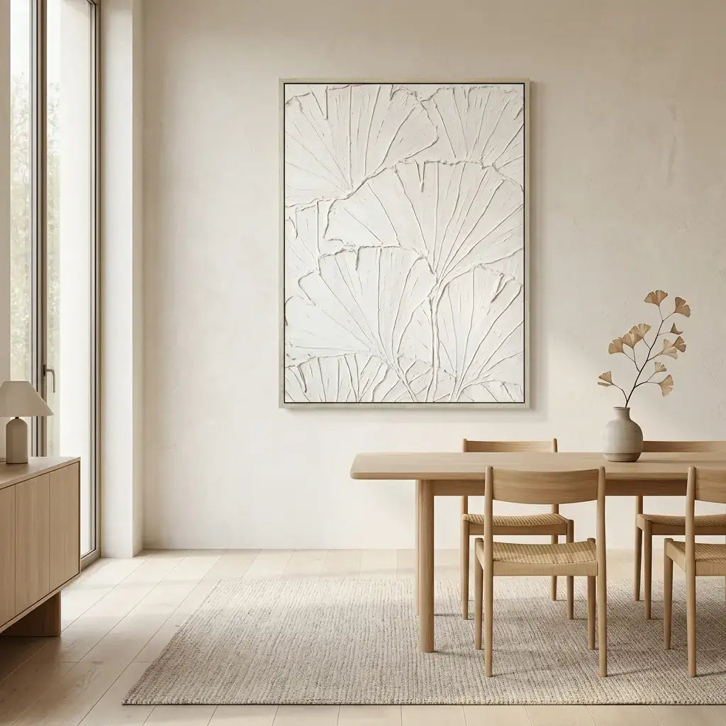 Dining room with wooden table and chairs, abstract artwork on the wall, and a vase with flowers.