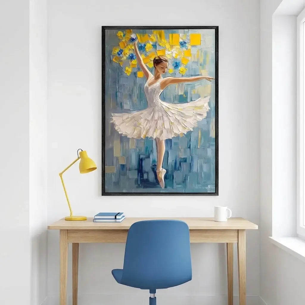 Framed painting of a dancer on a wall above a desk with a lamp and chair.