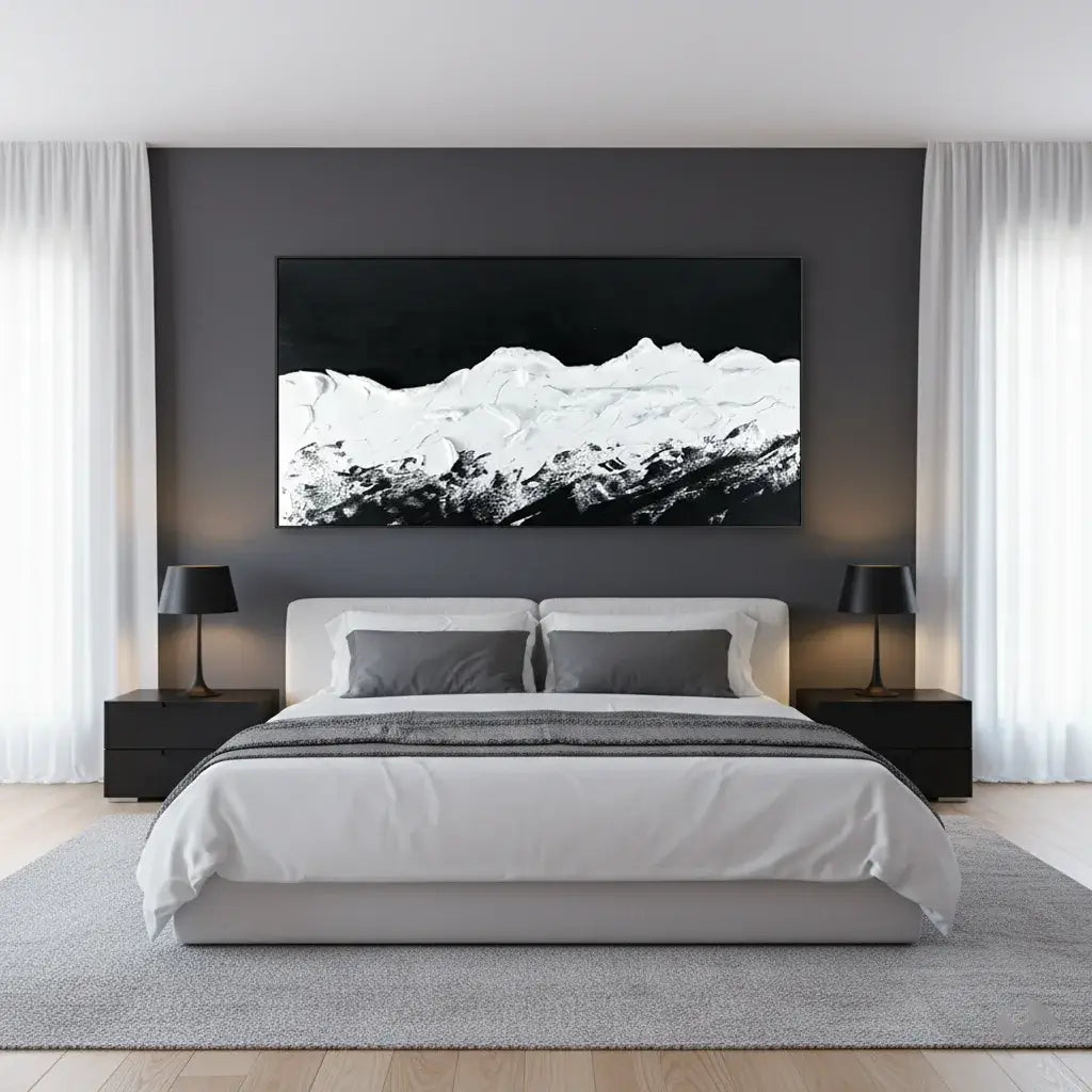 Modern bedroom with a large bed, nightstands, and a mountain landscape painting on the wall.