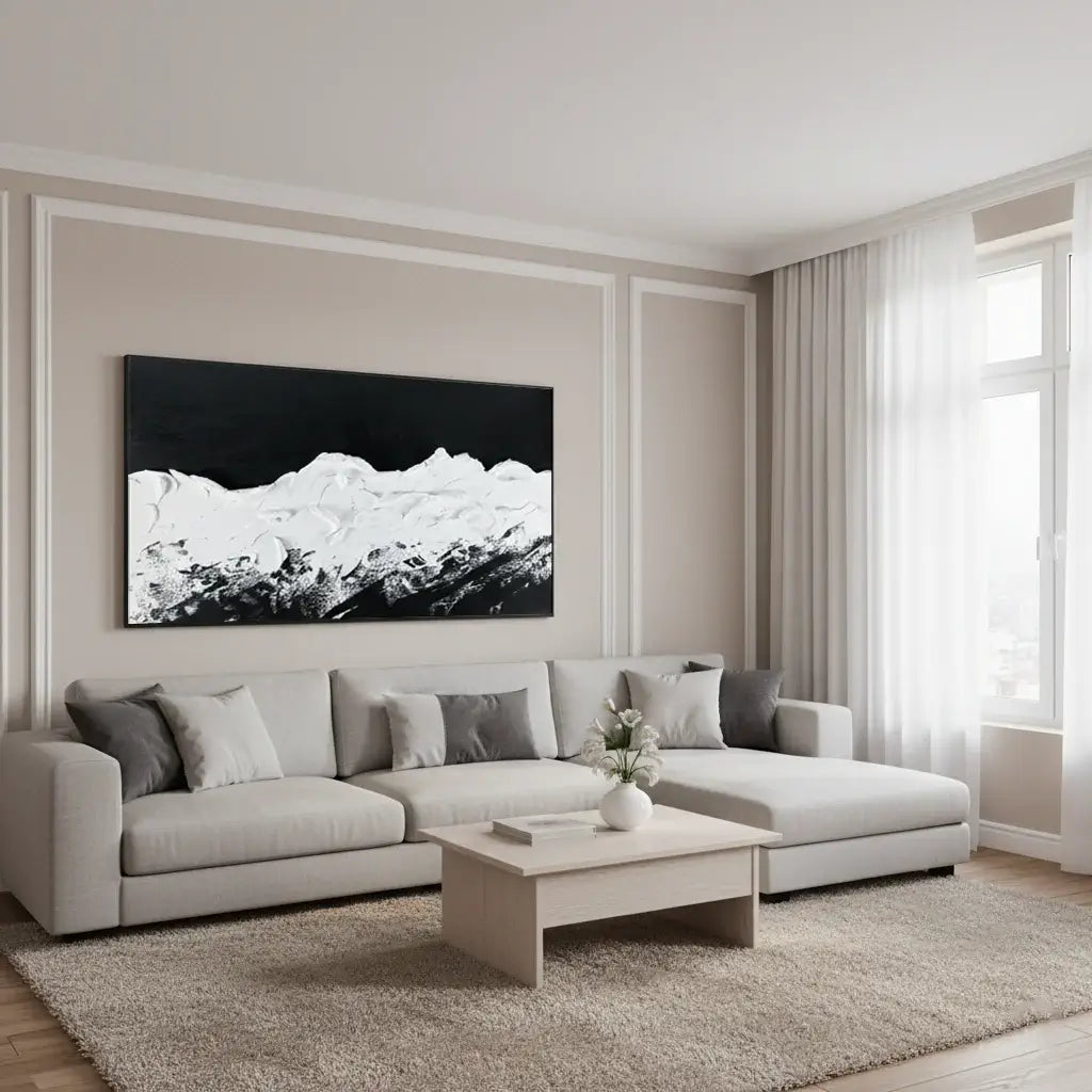 Modern living room with a gray sectional sofa, coffee table, and large mountain landscape painting.