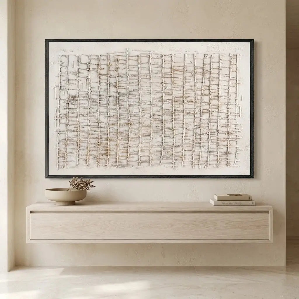 Framed abstract art on a wall above a wooden console table.