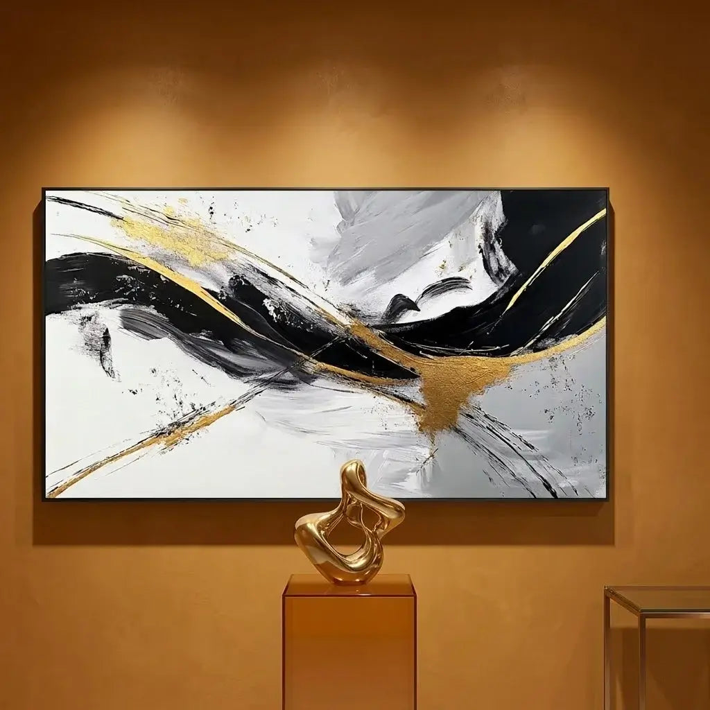 Modern living room with abstract art on the wall, black sofa, and marble accents.