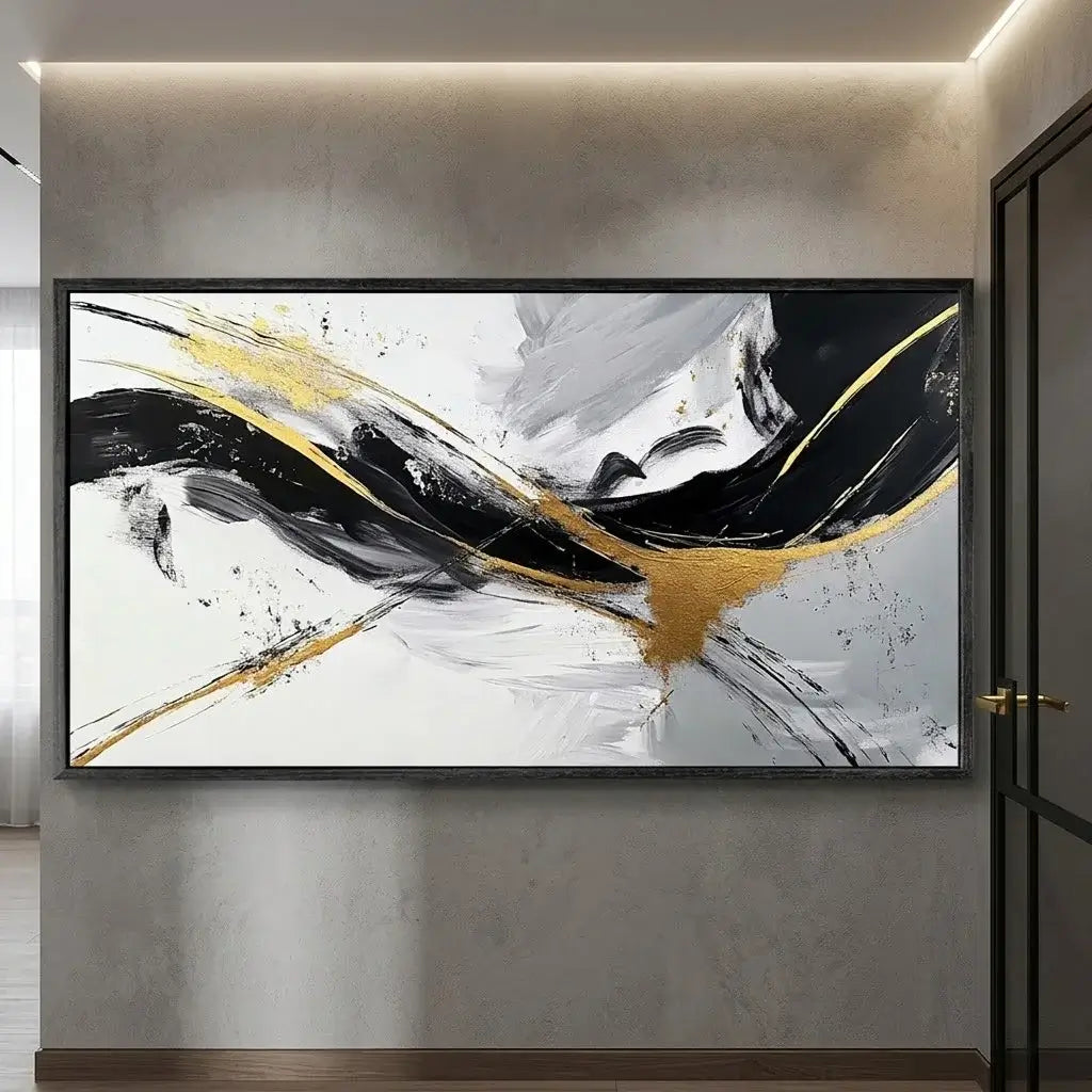 Abstract painting with black and gold strokes on a beige wall above a wooden bench.
