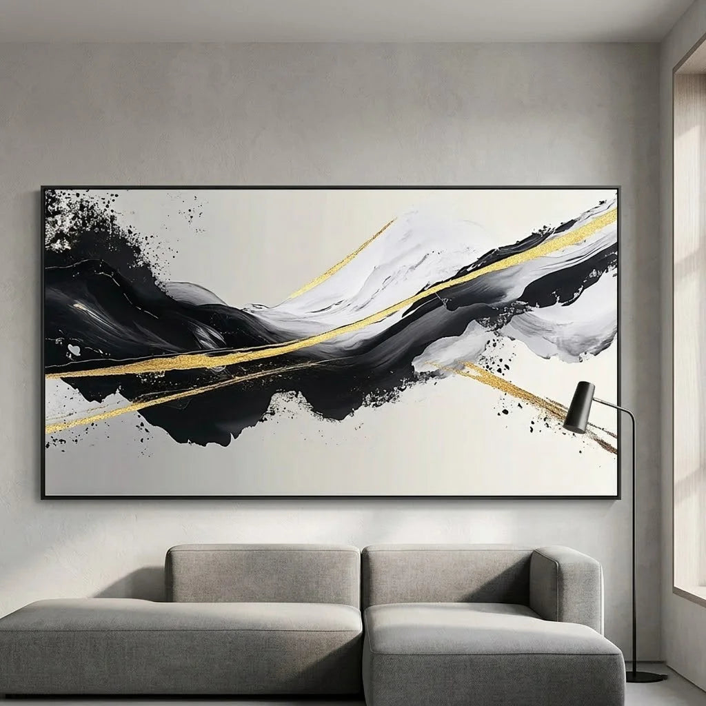 Abstract art piece on a marble wall above a dining table with black chairs.
