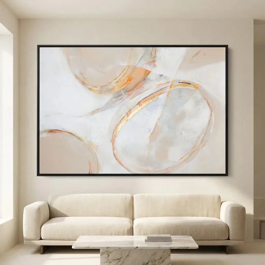 Abstract art piece on a wall above a beige sofa in a modern living room.