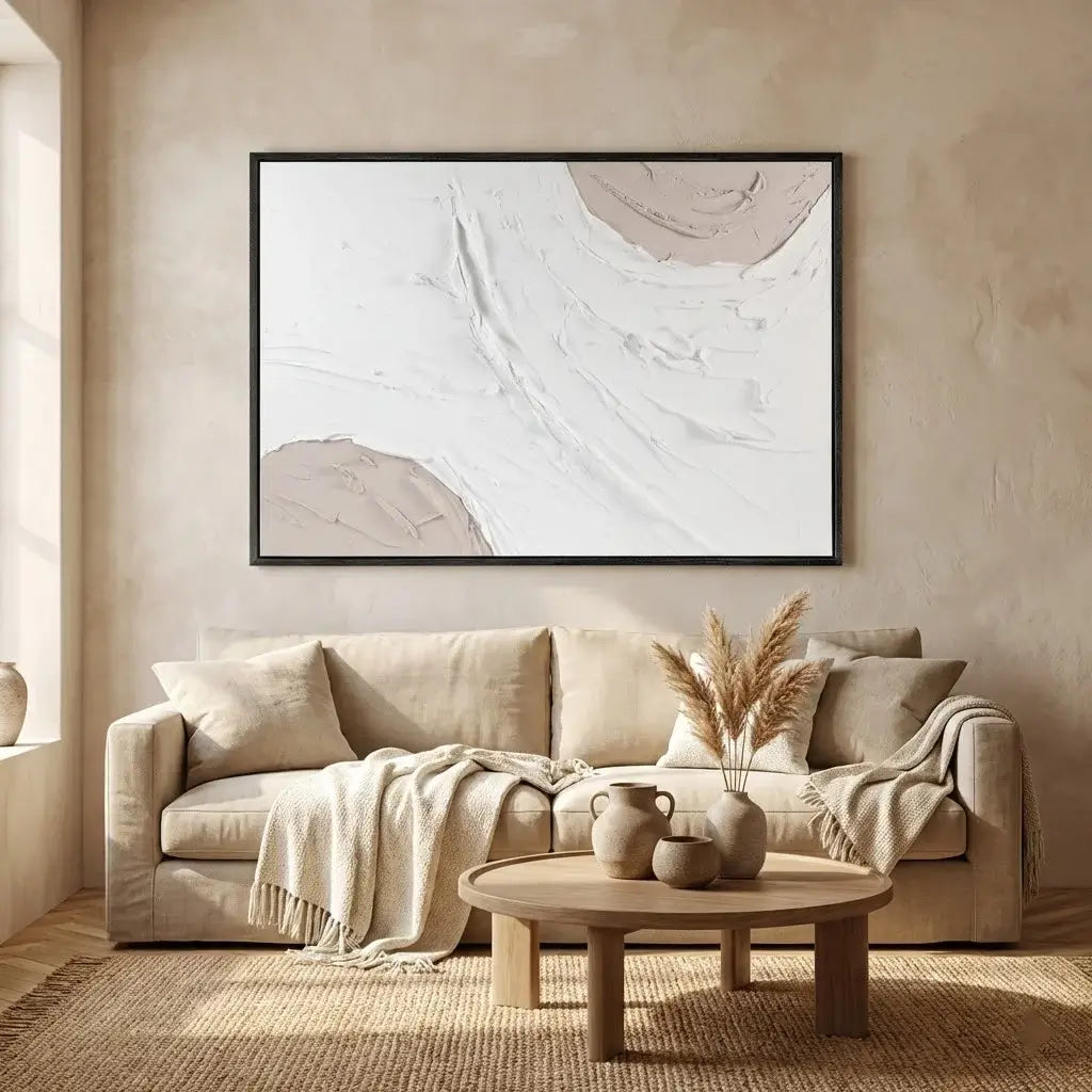 Beige sofa in a living room with abstract art on the wall