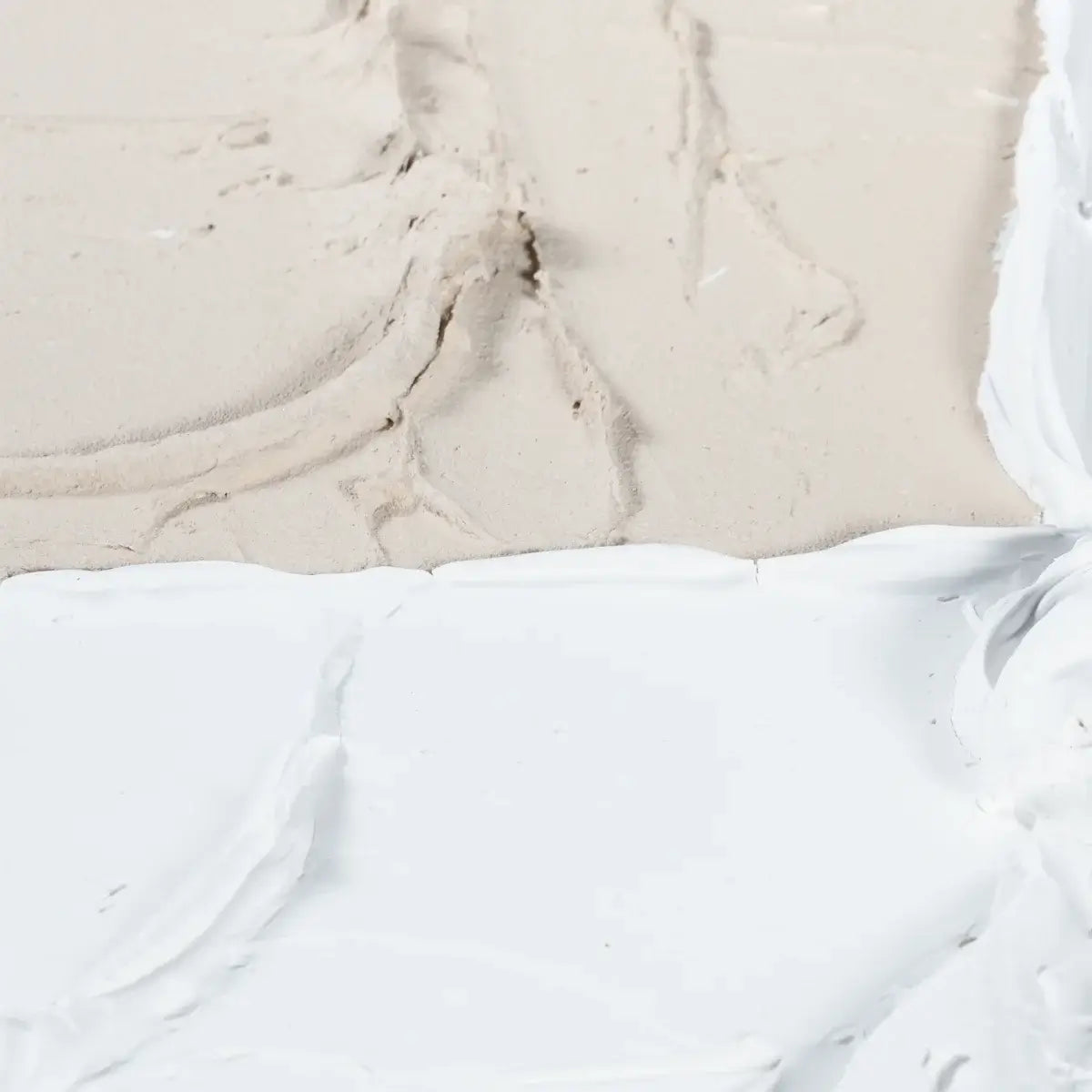 Close-up of a textured beige surface and white fabric