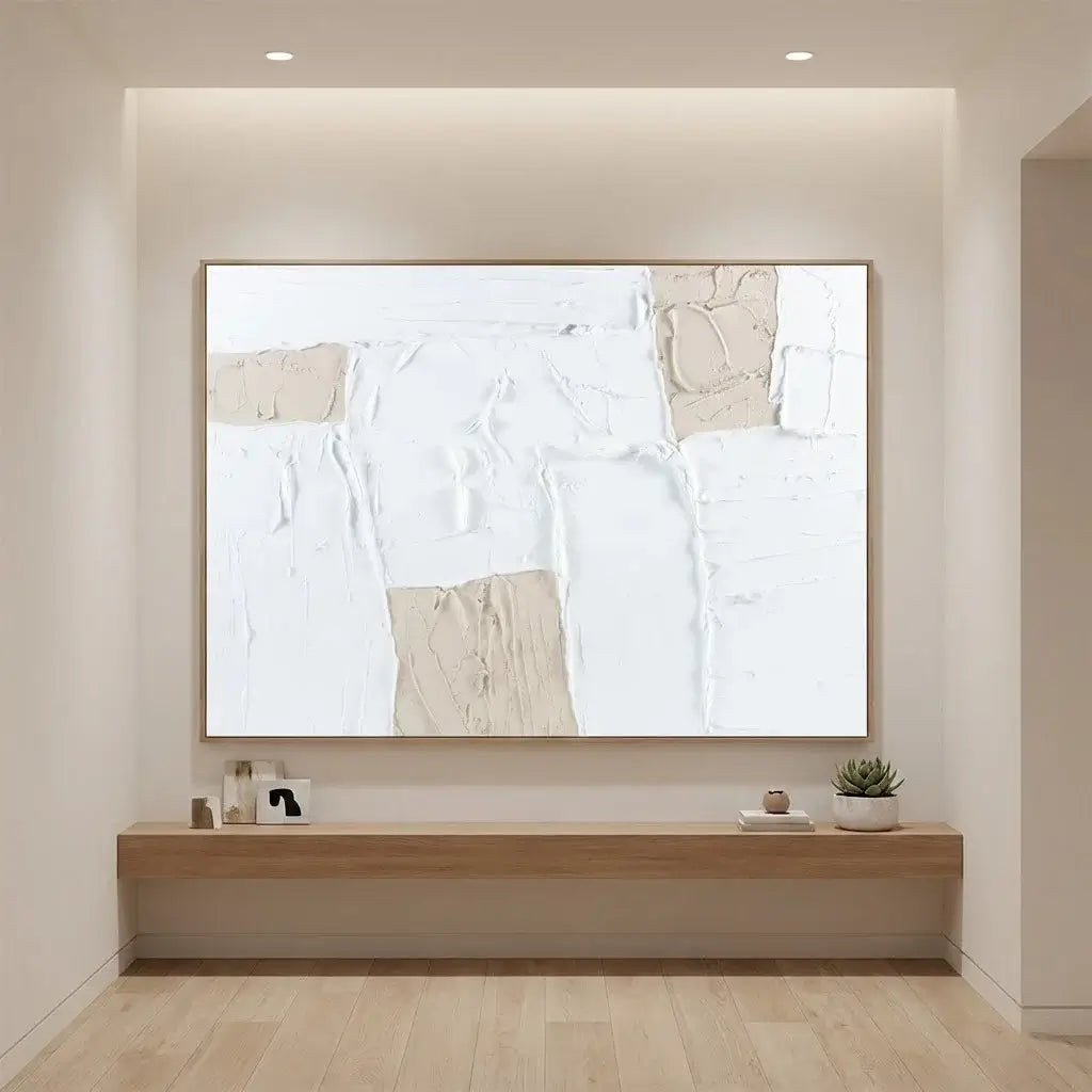 Large abstract art on a wall with a wooden console below in a modern room.
