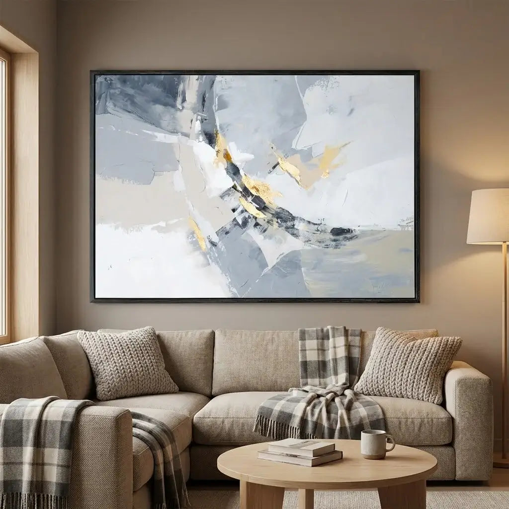 Living room with a beige sectional sofa, abstract painting on the wall, and a small round table.