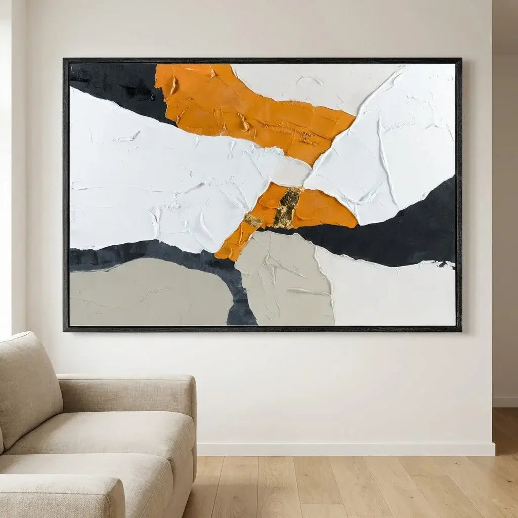 Abstract art piece on a wall above a sofa in a living room