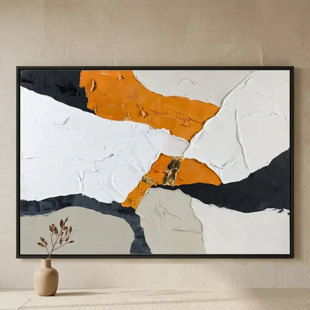 Abstract art piece on a concrete wall with a brown leather chair and side table.