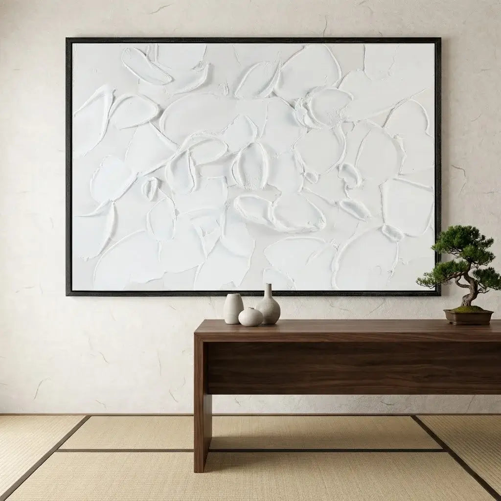 Abstract white painting on a wall with a wooden console table below