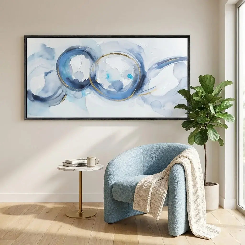 Modern interior with a blue armchair, abstract painting, and plant.