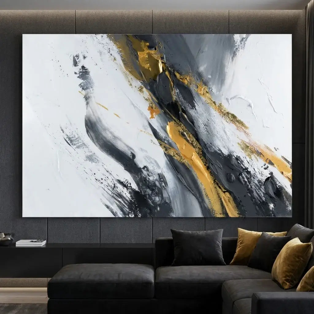 Abstract art painting with gold and black strokes on a wall above a dark sofa.
