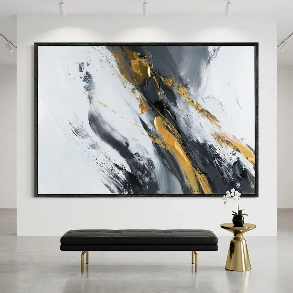 Abstract art piece with gold and black accents in a modern interior setting.