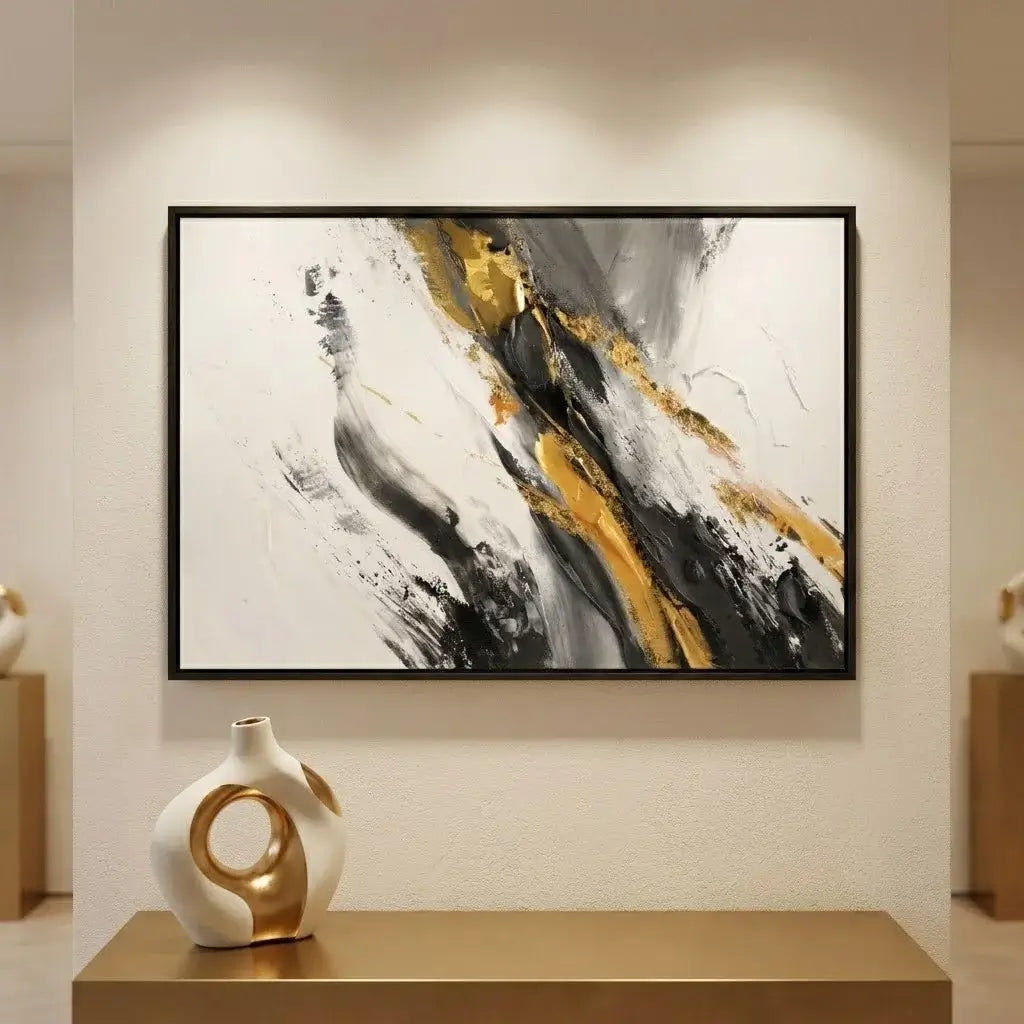 Abstract art piece with gold and black accents in a modern interior setting.