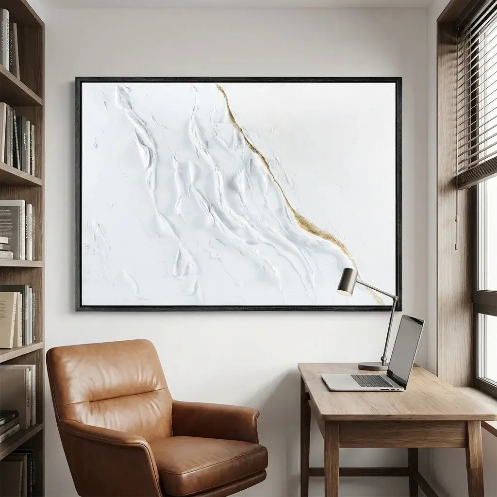 Modern home office with a brown leather chair, wooden desk, and abstract wall art.