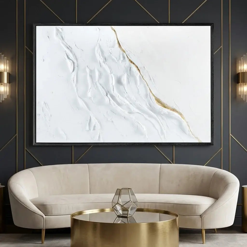 Modern living room with a beige sofa, gold coffee table, and abstract marble art on the wall.