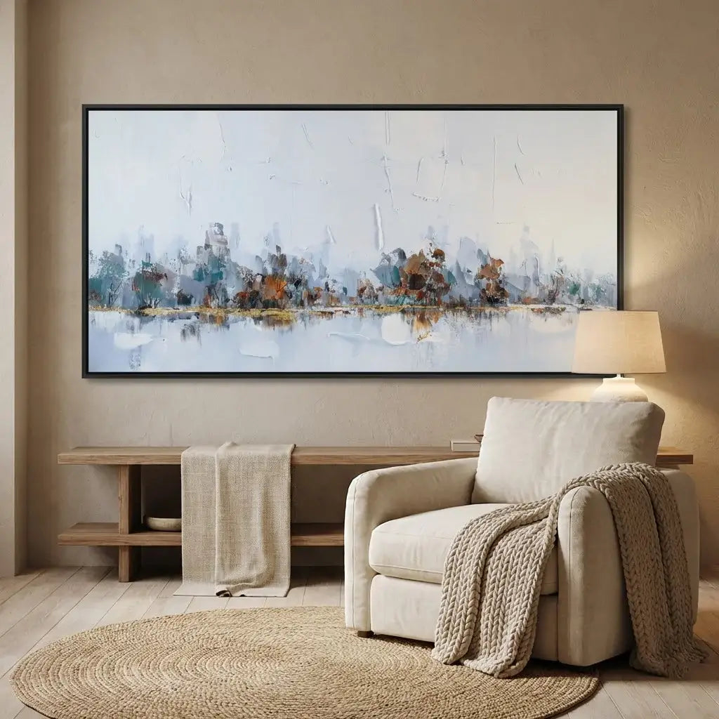 Living room with a large abstract painting on the wall, beige armchair, and wooden side table.