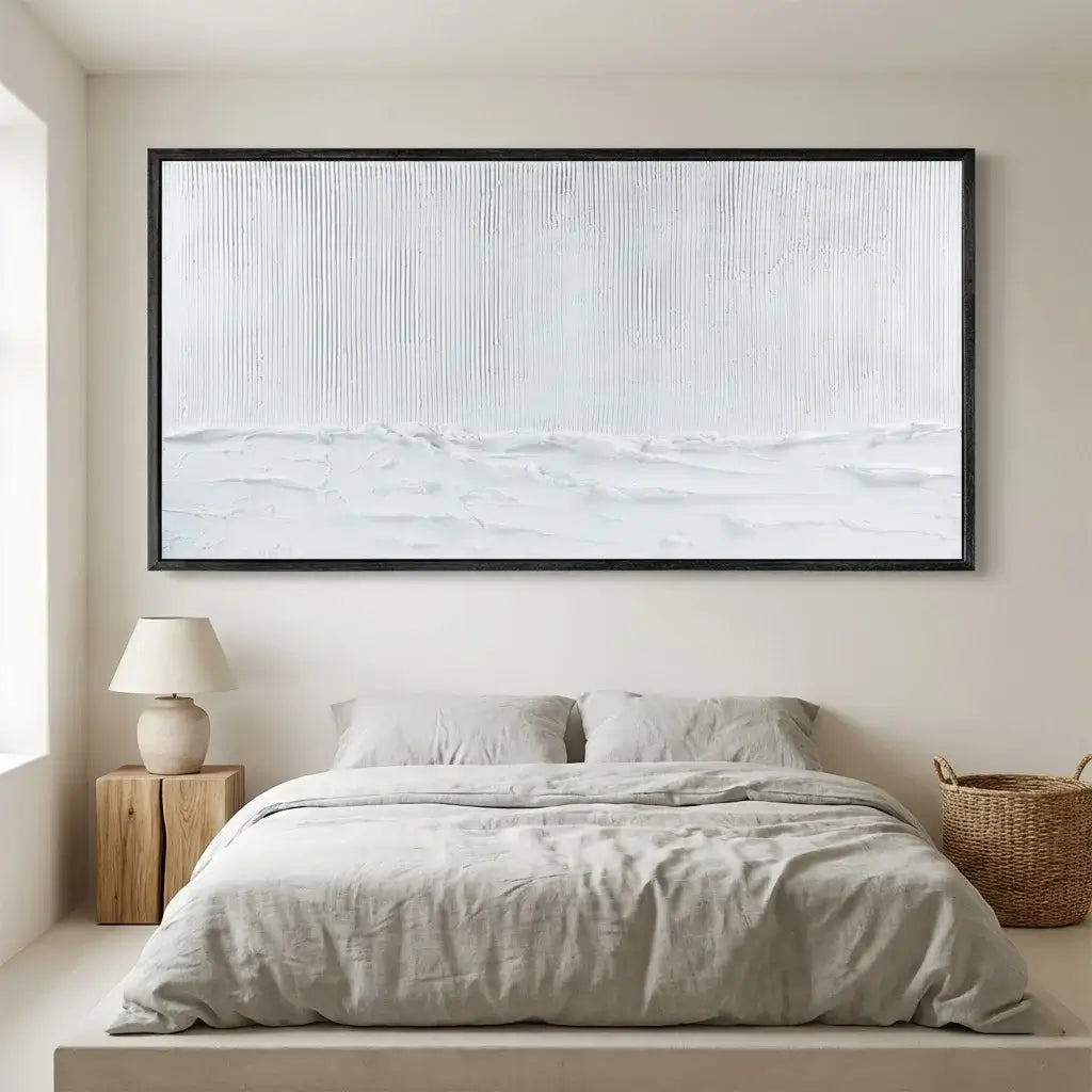 Bedroom with a large framed abstract painting above the bed