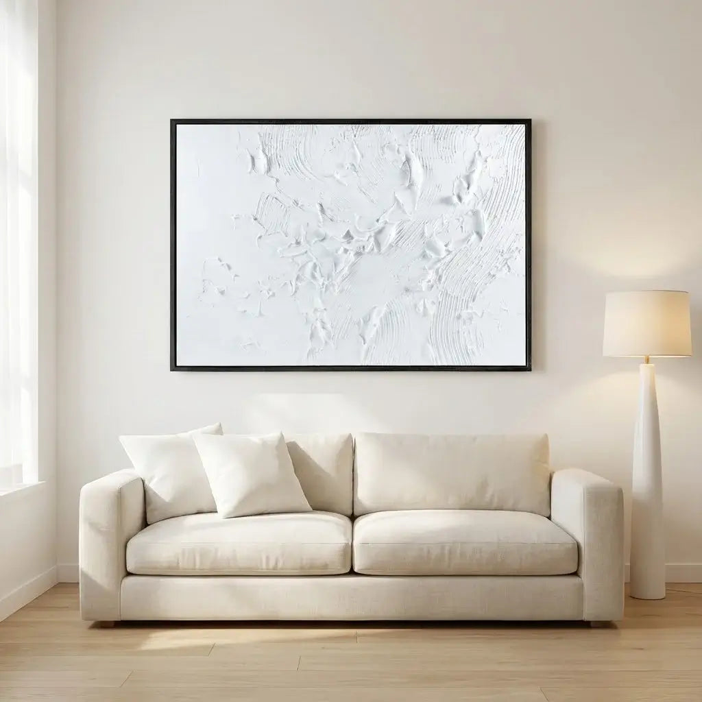 Beige sofa in a living room with a large abstract painting on the wall.
