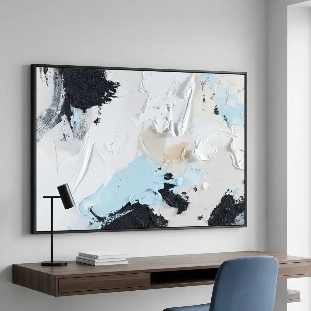 Abstract painting on a wall above a desk with a chair.