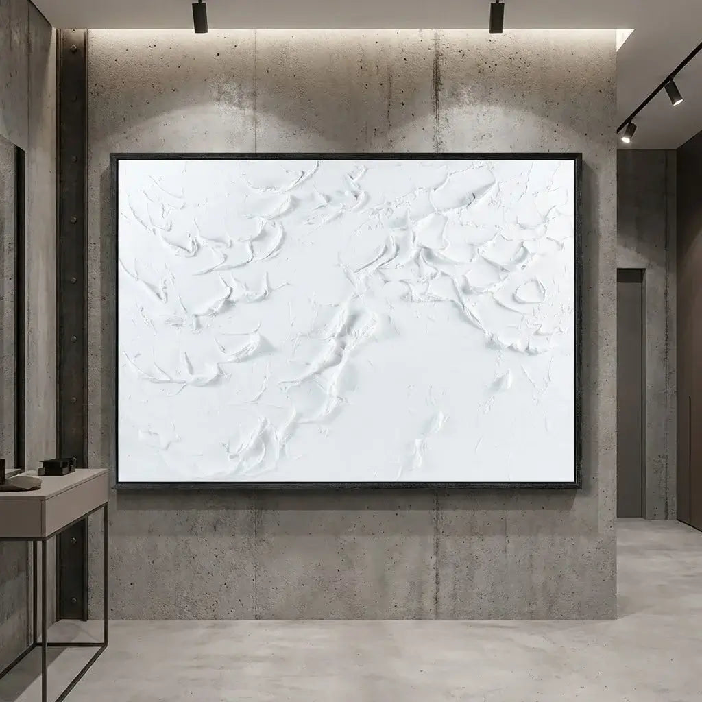 Abstract white artwork on a textured wall in a modern interior setting
