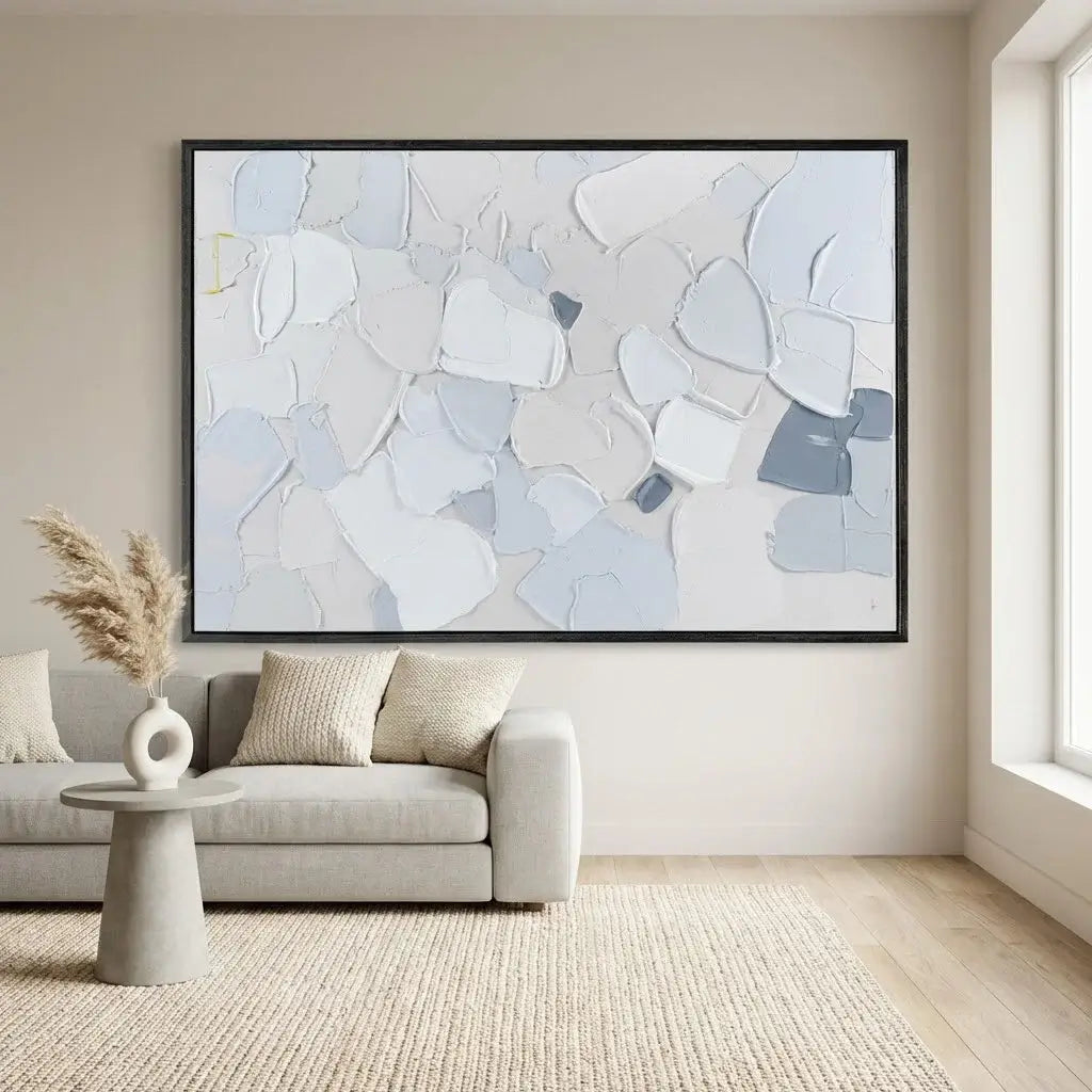 Living room with a large abstract painting on the wall, a sofa, and a small table.