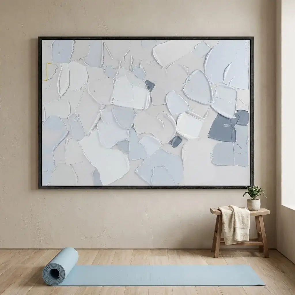 Abstract art piece in a modern interior setting with a yoga mat and stool.
