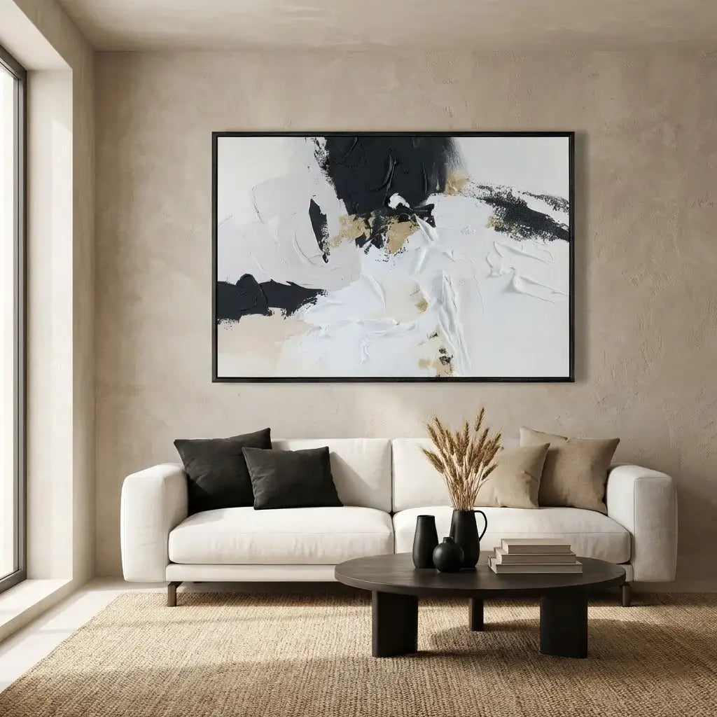 Modern living room with a white sofa, abstract art, and decorative items.