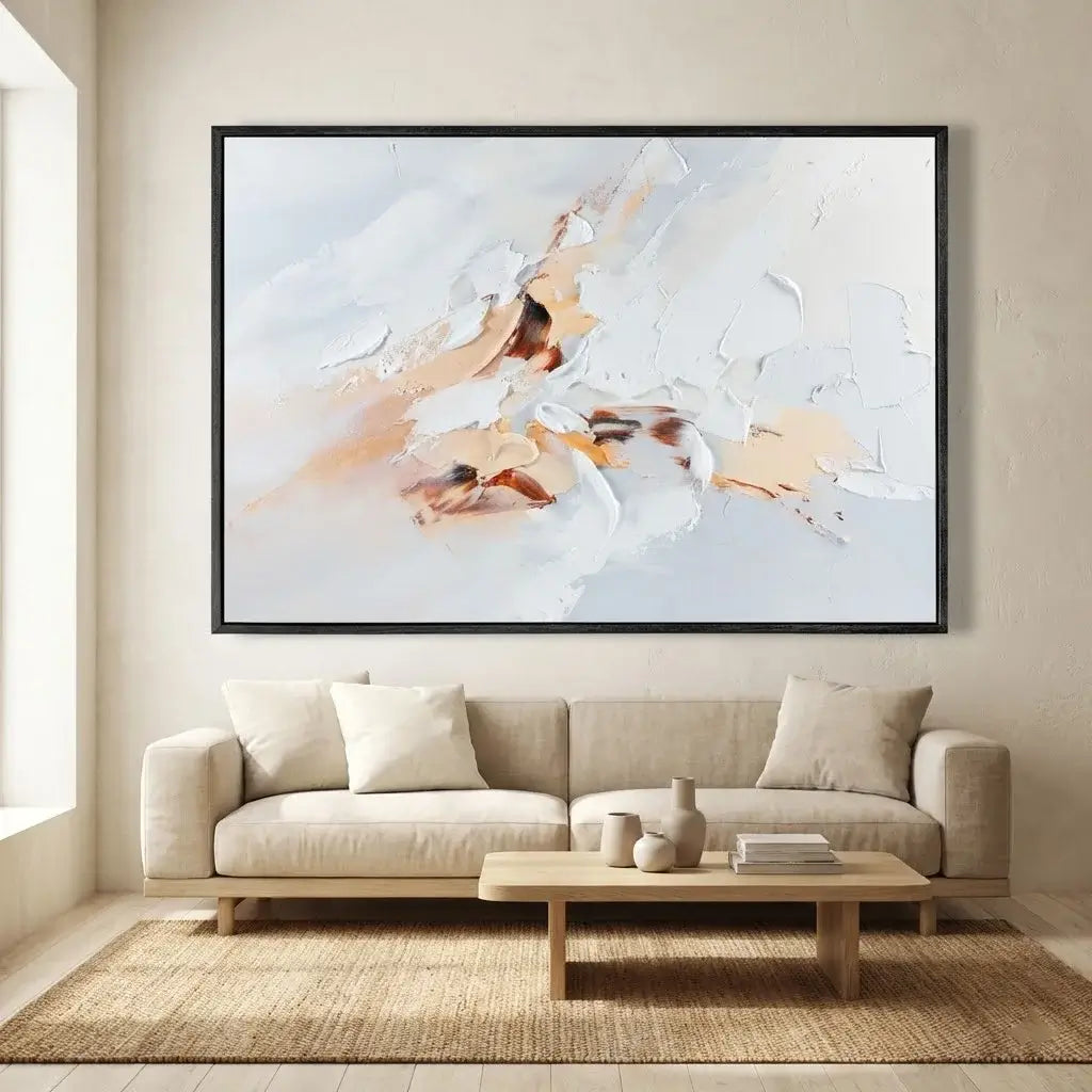 Abstract painting above a beige sofa in a living room