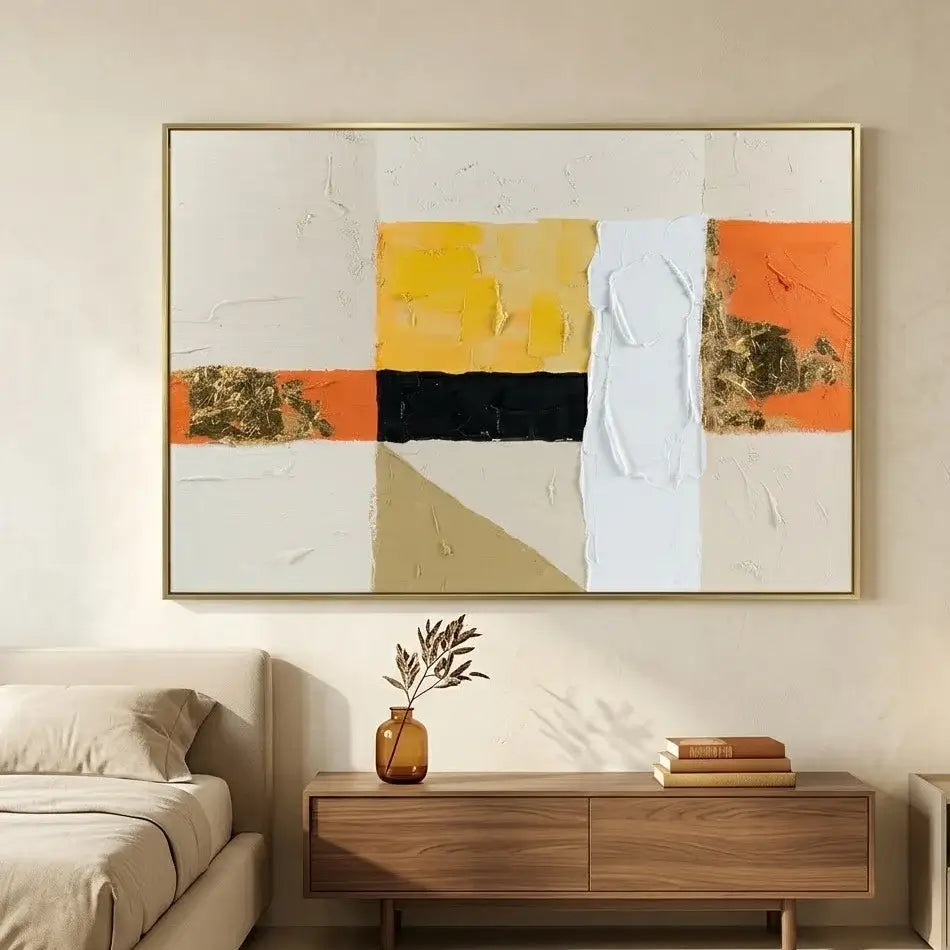 Abstract art piece on a wall above a chair in a living room setting.