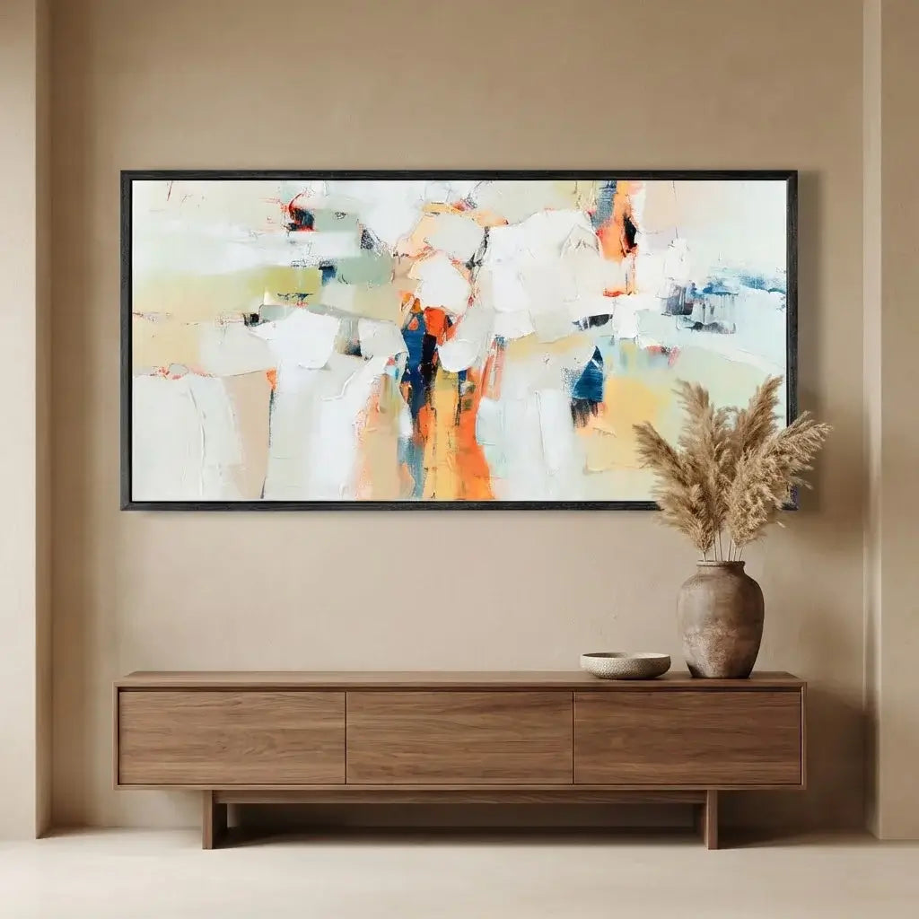 Abstract painting on a wall above a wooden console table with decorative items.