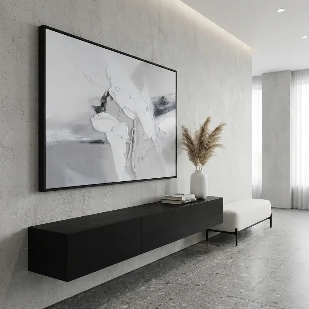Modern living room with abstract art on the wall, black console table, and white bench.