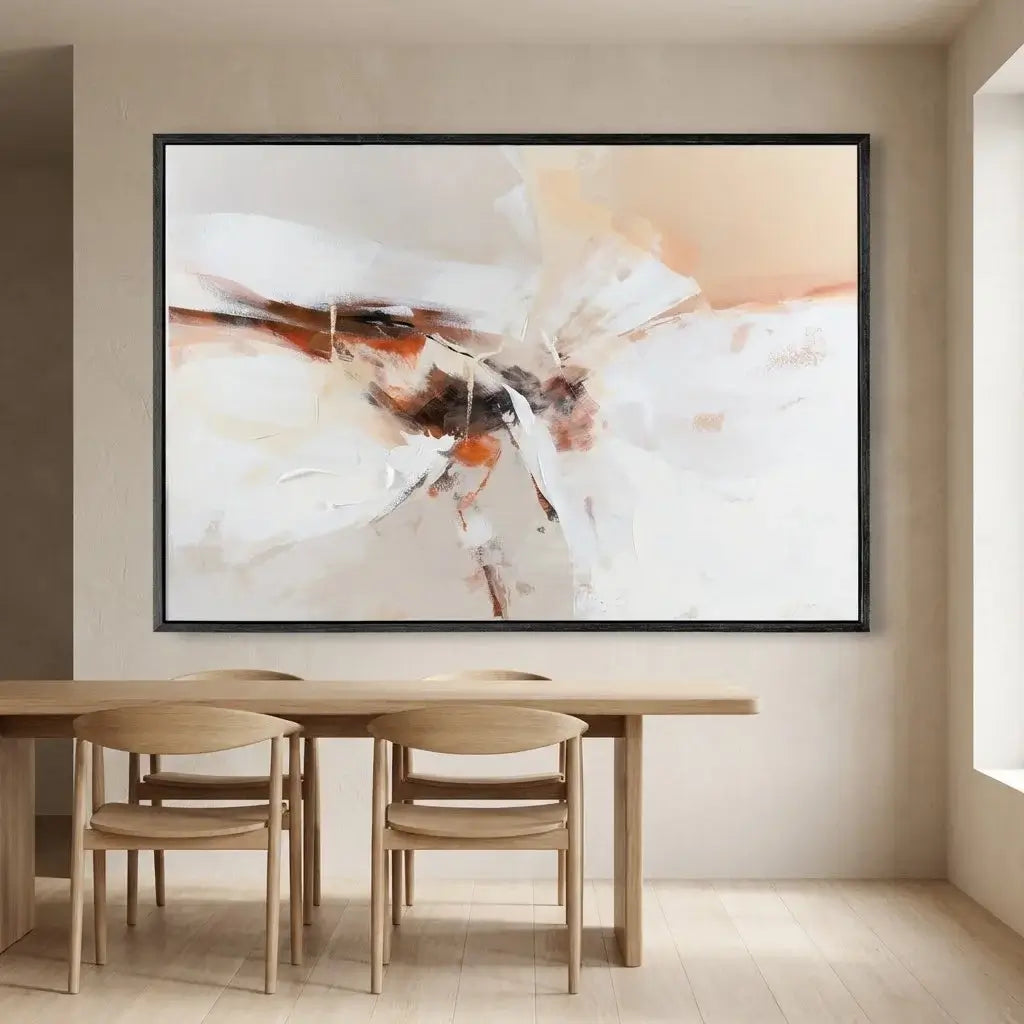 Abstract painting on a wall above a wooden dining table with chairs.