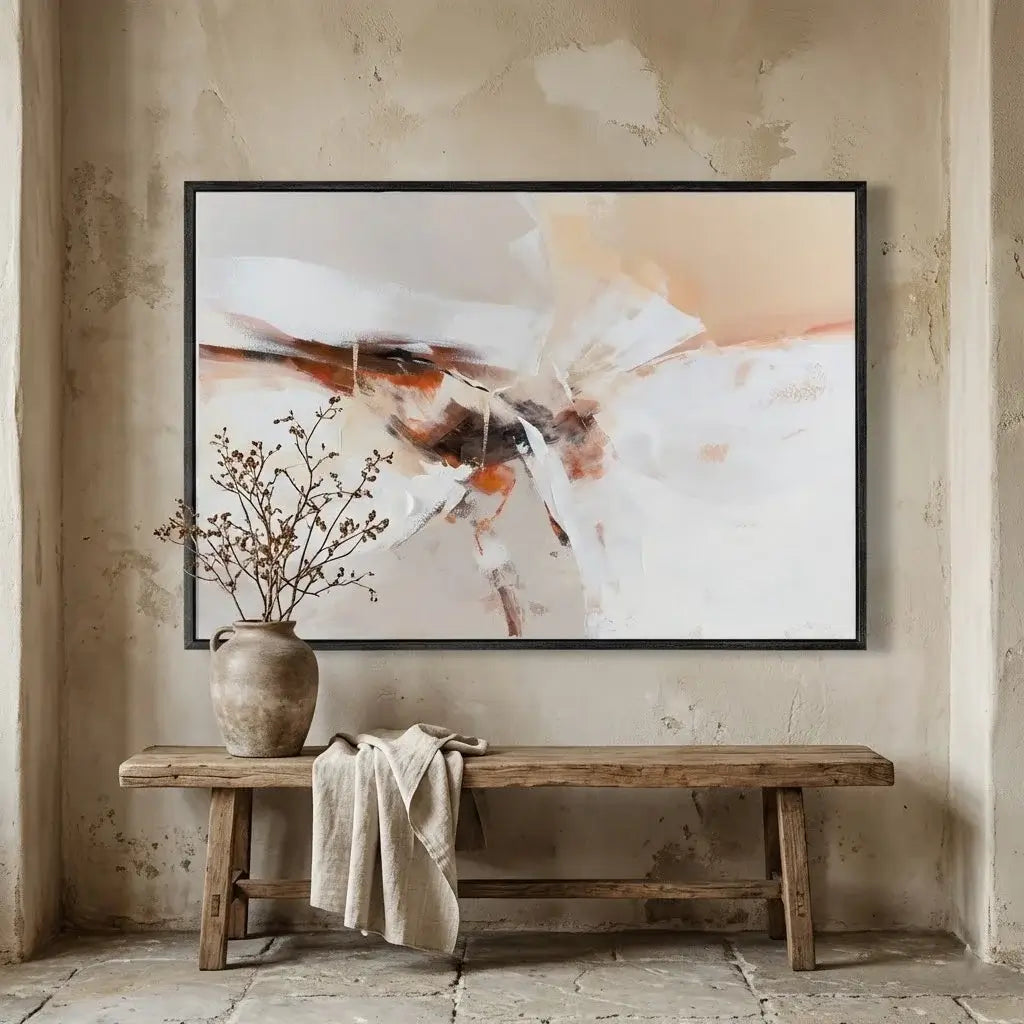 Abstract art piece on a textured wall above a wooden bench with a vase and cloth.